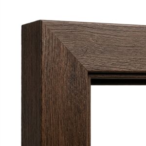 Close-up of a seamless corner joint on a wood-grain textured fiberglass door frame.